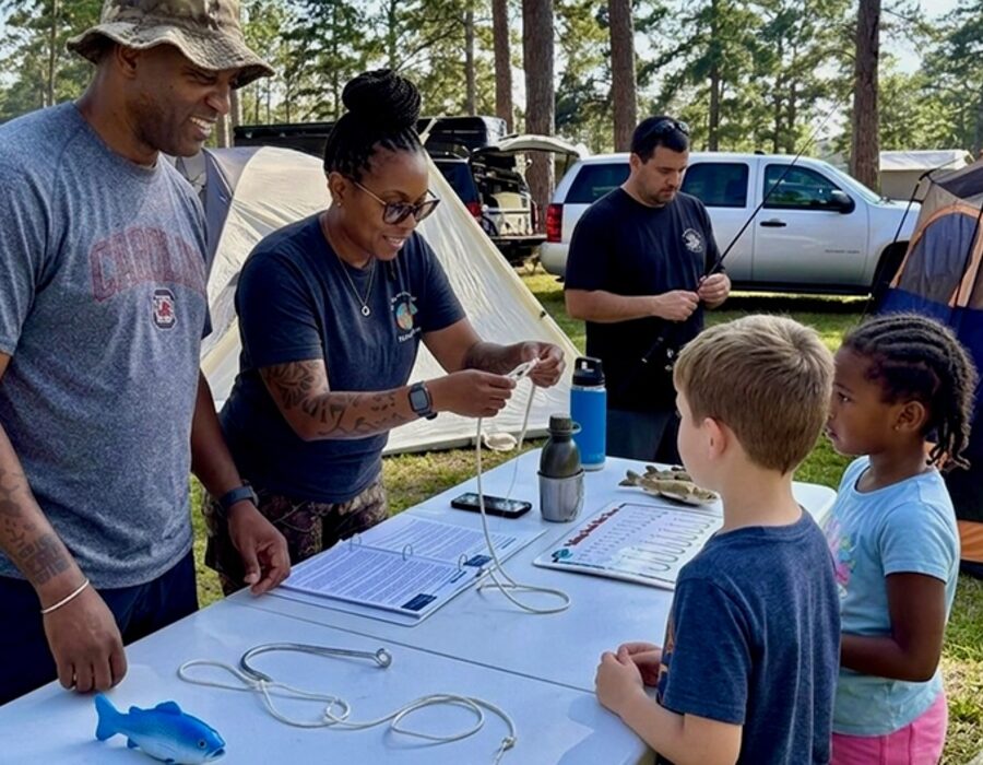 RHF instructors teaching children about fishing regulations and knot-tying at an outdoor clinic